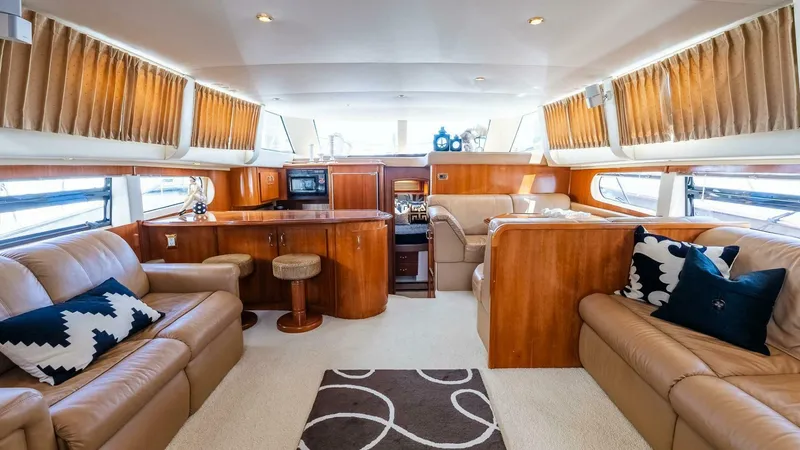 Slide: The Image of Luxurious interior of 2004 Carver 466 Motor Yacht with leather seating and wood finishes. - 11