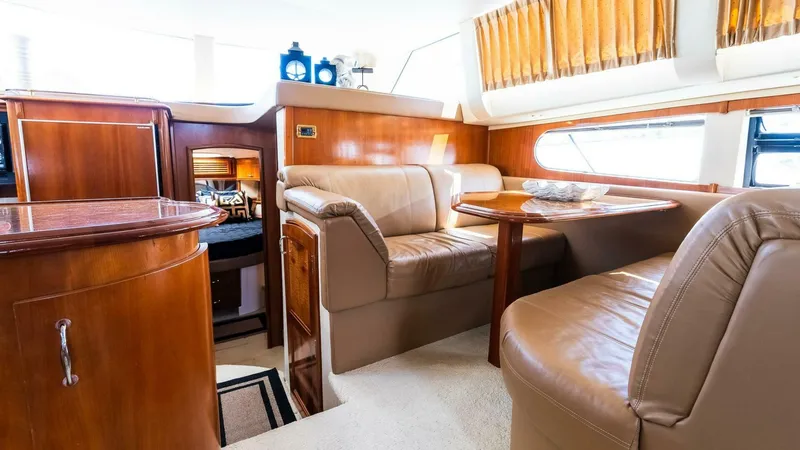 Slide: The Image of Interior of 2004 Carver 466 Motor Yacht with luxurious seating and wooden finishes. - 19