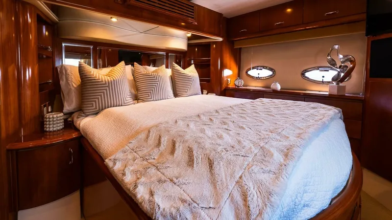 Slide: The Image of Luxurious bedroom interior of 2004 Carver 466 Motor Yacht with elegant bedding and wood finishes. - 21