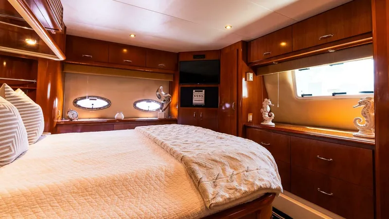 Slide: The Image of Luxurious bedroom interior of 2004 Carver 466 Motor Yacht with elegant wood finish. - 22