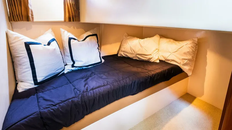 Slide: The Image of Cozy cabin bed in 2004 Carver 466 Motor Yacht with pillows and navy bedding. - 25