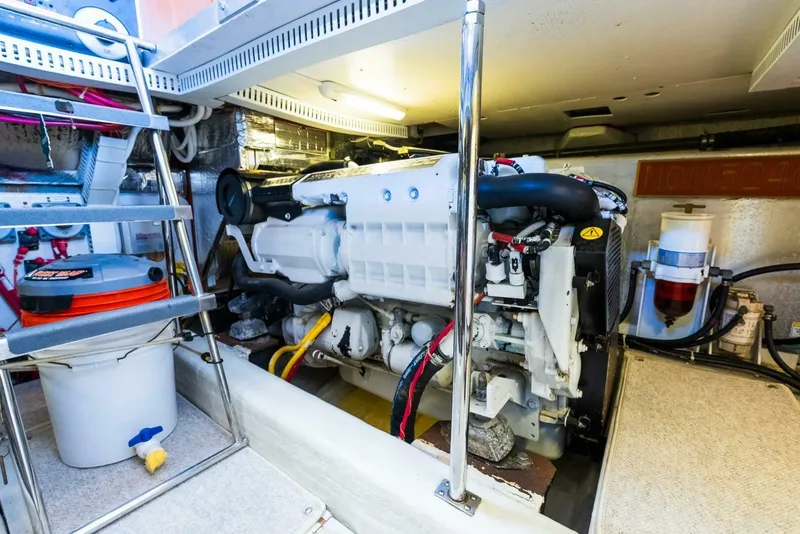 Slide: The Image of Engine room of 2004 Carver 466 Motor Yacht, featuring a well-maintained engine and equipment. - 31