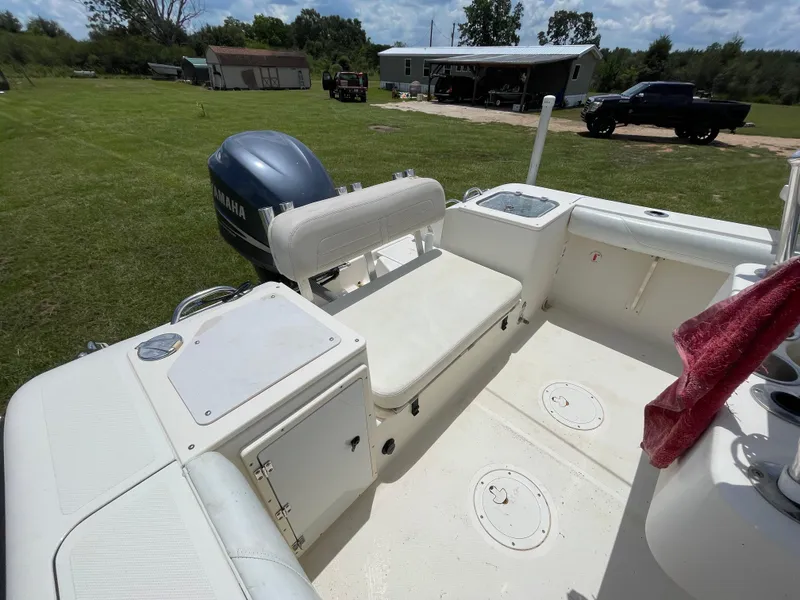 Slide: The Image of 2008 Pursuit 230 Center Console boat with Yamaha engine, parked on grassy area. - 10