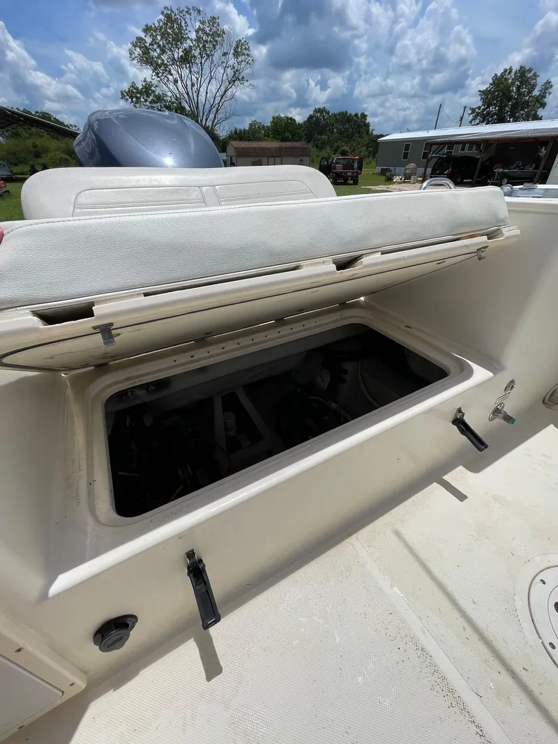 Slide: The Image of 2008 Pursuit 230 Center Console boat with open storage compartment. - 11