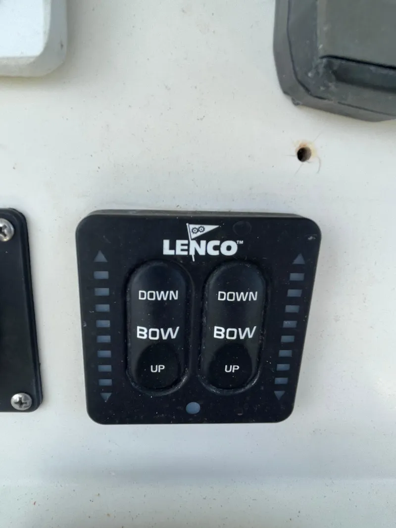 Slide: The Image of Lenco trim tab control on 2008 Pursuit 230 Center Console boat. - 16
