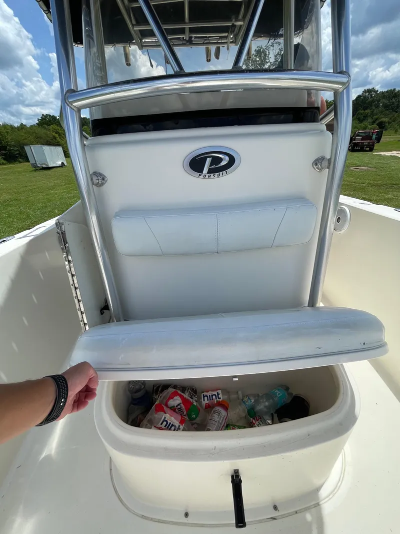 Slide: The Image of 2008 Pursuit 230 Center Console boat with open storage compartment. - 21