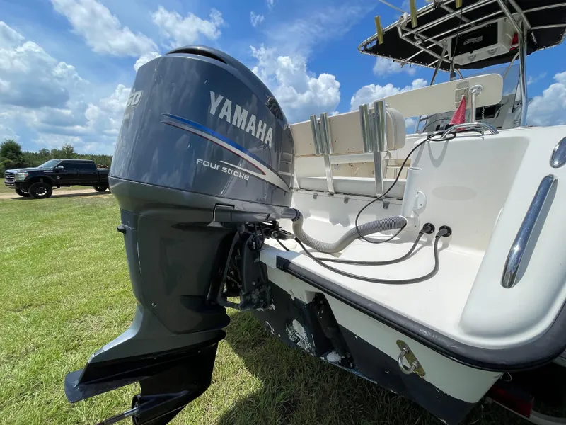 Slide: The Image of 2008 Pursuit 230 Center Console with Yamaha outboard motor on grassy field. - 5