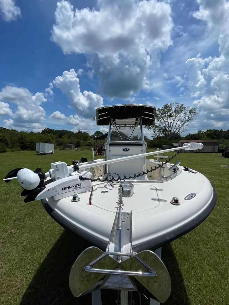 Slide: The Image of 2008 Pursuit 230 Center Console boat on grassy field under cloudy sky. - 8