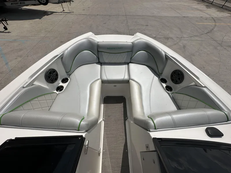 Slide: The Image of 2014 MasterCraft X2 boat interior with silver seating and green accents. - 10