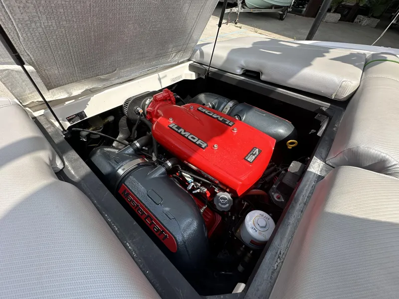 Slide: The Image of 2014 MasterCraft X2 engine compartment with Ilmor motor, showcasing red and black components. - 12