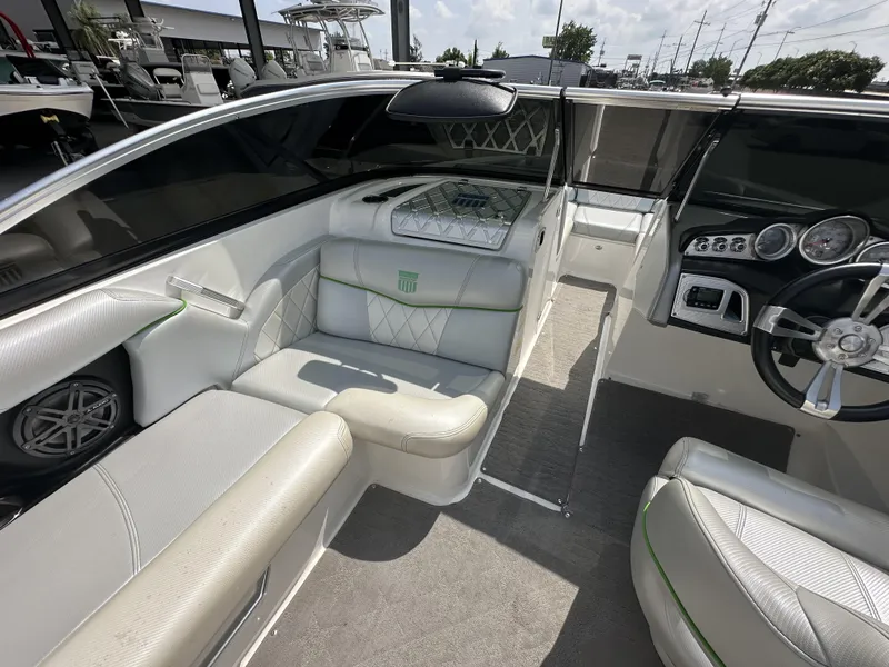Slide: The Image of 2014 MasterCraft X2 boat interior with white seating and modern dashboard. - 13