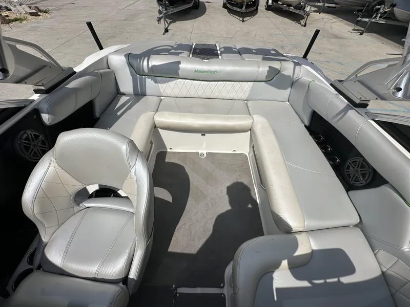 Slide: The Image of 2014 MasterCraft X2 boat interior with gray seating and carpeted floor. - 17