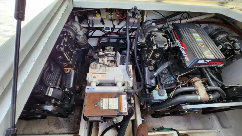Slide: The Image of Engine compartment of 1999 Bayliner Cierra 3055 with dual engines and mechanical components. - 12