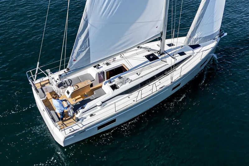 Slide: The Image of 2024 Bavaria C38 yacht sailing on open water, showcasing sleek design and spacious deck. - 15