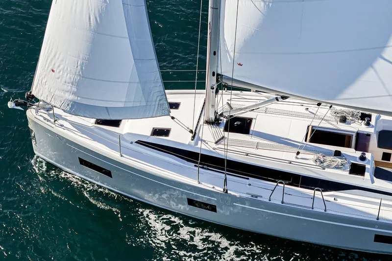 Slide: The Image of 2024 Bavaria C38 yacht sailing on open water, showcasing sleek design and white sails. - 19