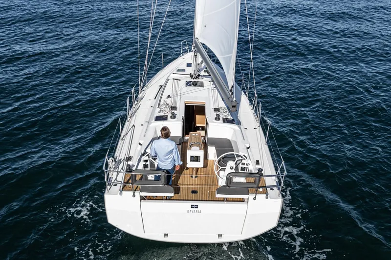 Slide: The Image of 2024 Bavaria C38 sailboat cruising on open water, viewed from above. - 25