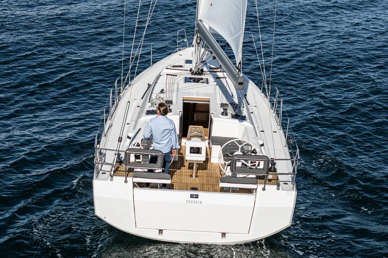 Slide: The Image of 2024 Bavaria C38 yacht sailing on open water, rear view. - 26