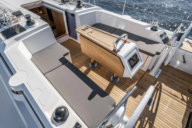 Slide: The Image of 2024 Bavaria C38 yacht cockpit with teak flooring and cushioned seating. - 33