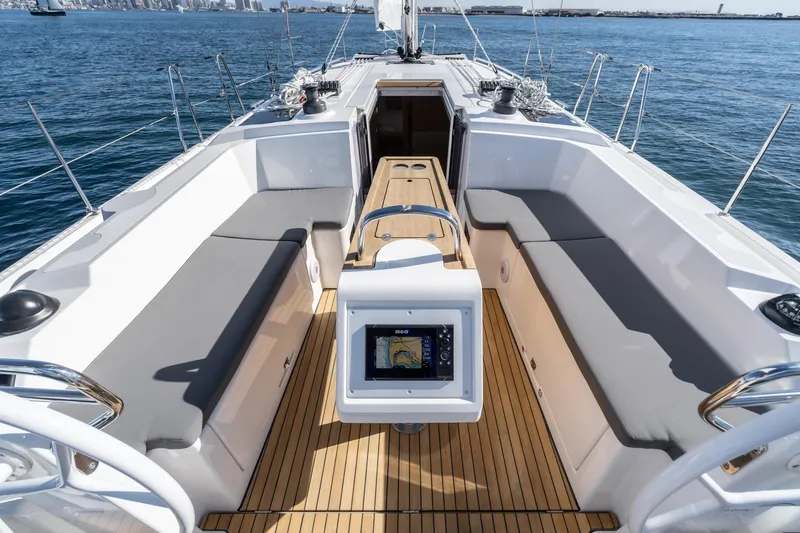 Slide: The Image of 2024 Bavaria C38 yacht cockpit with modern navigation system, spacious seating, and teak flooring. - 34
