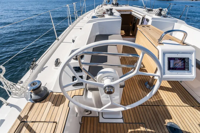 Slide: The Image of 2024 Bavaria C38 yacht cockpit with steering wheel and navigation display. - 41