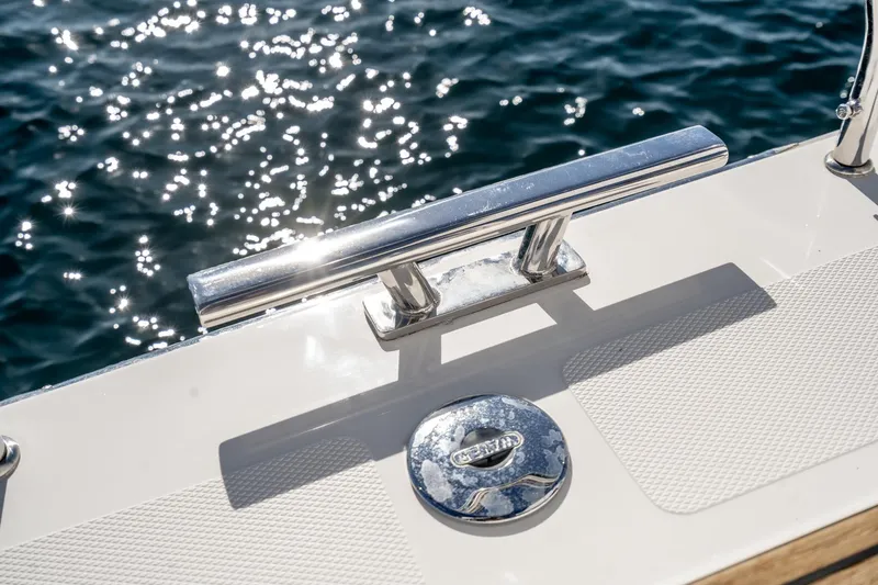Slide: The Image of Bavaria C38 2024 yacht deck detail with cleat and Bavaria logo, sparkling water background. - 48