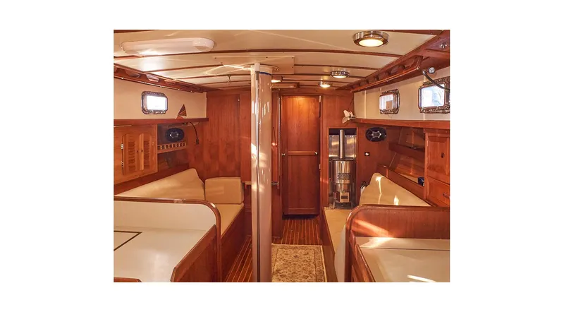 The Image of Interior of 1983 Valiant 40 Selah yacht with wooden furnishings and cozy seating. - 0
