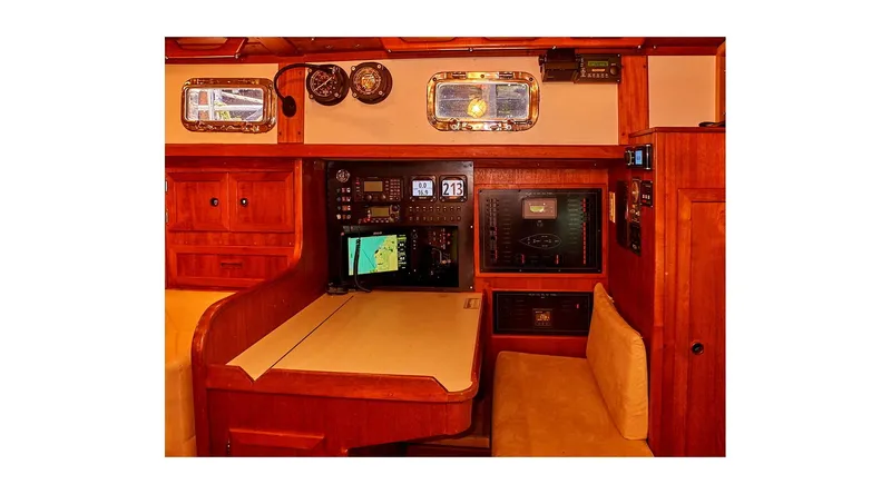Slide: The Image of Interior of 1983 Valiant 40 Selah yacht with navigation equipment and wooden furnishings. - 11