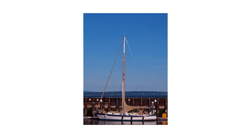 Slide: The Image of 1983 Valiant 40 Selah sailboat docked under clear blue sky. - 146