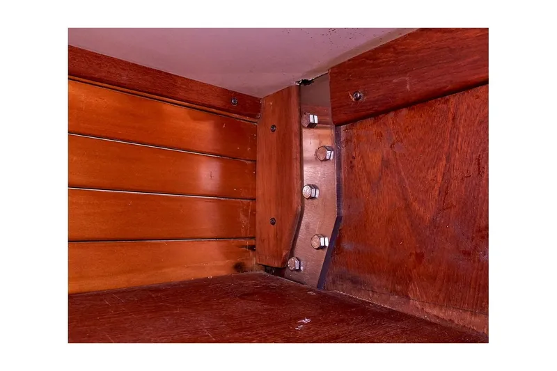 Slide: The Image of Interior woodwork of 1983 Valiant 40 Selah boat, showcasing bolts and paneling. - 17