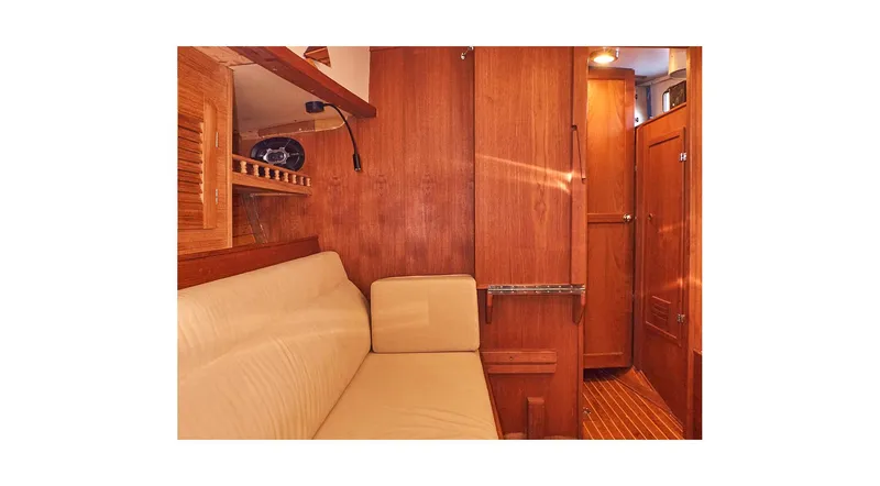 Slide: The Image of Interior of 1983 Valiant 40 Selah yacht with wooden paneling and beige seating. - 18