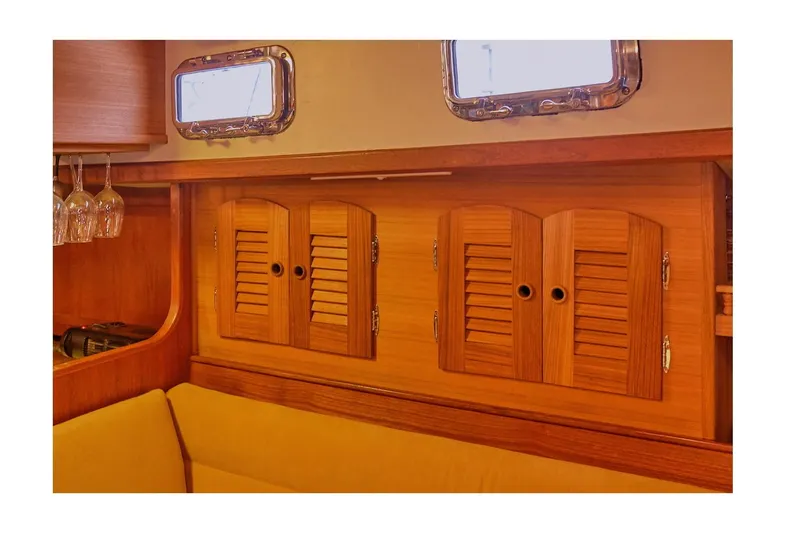 Slide: The Image of Interior of 1983 Valiant 40 Selah yacht with wooden cabinets and portholes. - 21