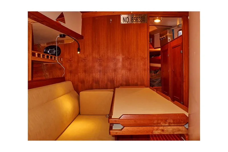 Slide: The Image of Interior of 1983 Valiant 40 Selah sailboat with wooden paneling and seating area. - 22