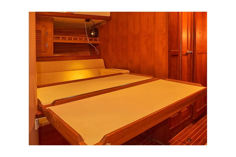 Slide: The Image of 1983 Valiant 40 Selah interior cabin with wooden finish and foldable table. - 25