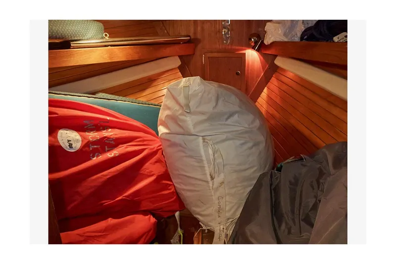 Slide: The Image of Interior of 1983 Valiant 40 Selah sailboat with sails and wooden paneling. - 29