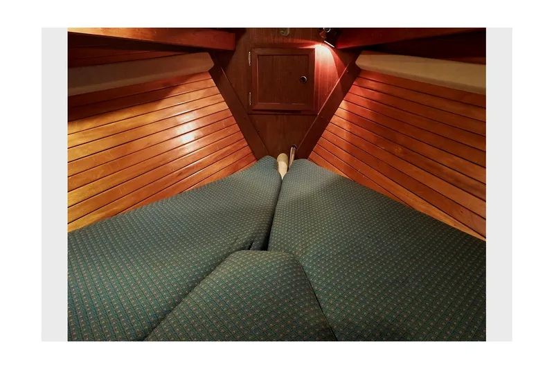 Slide: The Image of Interior cabin of 1983 Valiant 40 Selah sailboat with wooden paneling and cushioned seating. - 30