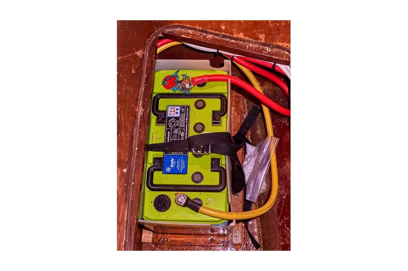 Slide: The Image of Battery compartment of 1983 Valiant 40 Selah with connected cables and secure straps. - 33