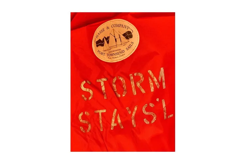 Slide: The Image of Red storm staysail with "Storm Stays'l" text and sailmaker's logo, Valiant 40 Selah, 1983. - 37
