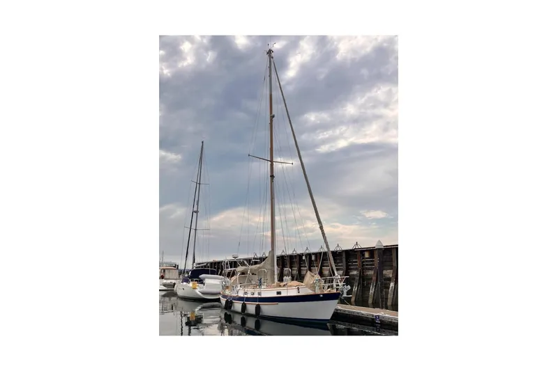 Slide: The Image of 1983 Valiant 40 Selah sailboat docked under cloudy sky. - 4