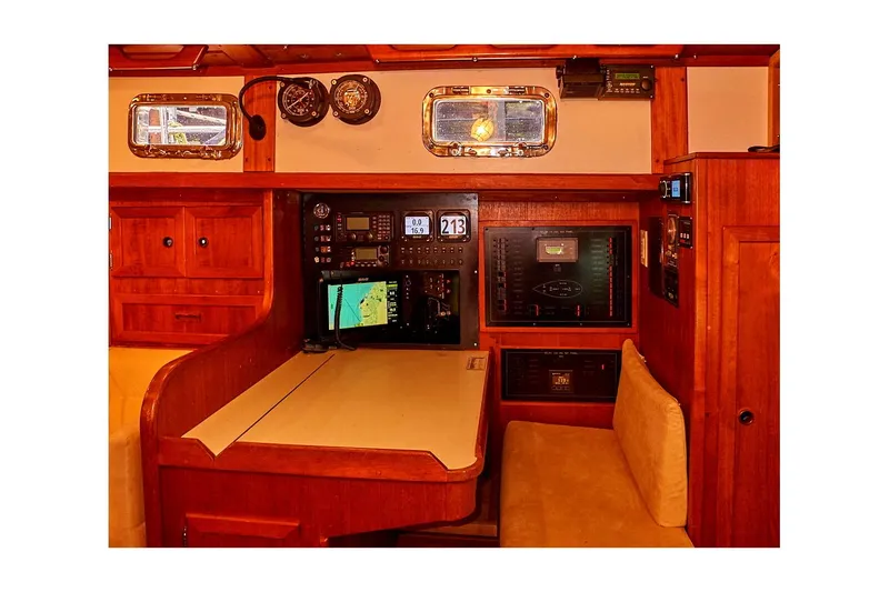 Slide: The Image of 1983 Valiant 40 Selah yacht interior with navigation station and wooden cabinetry. - 45