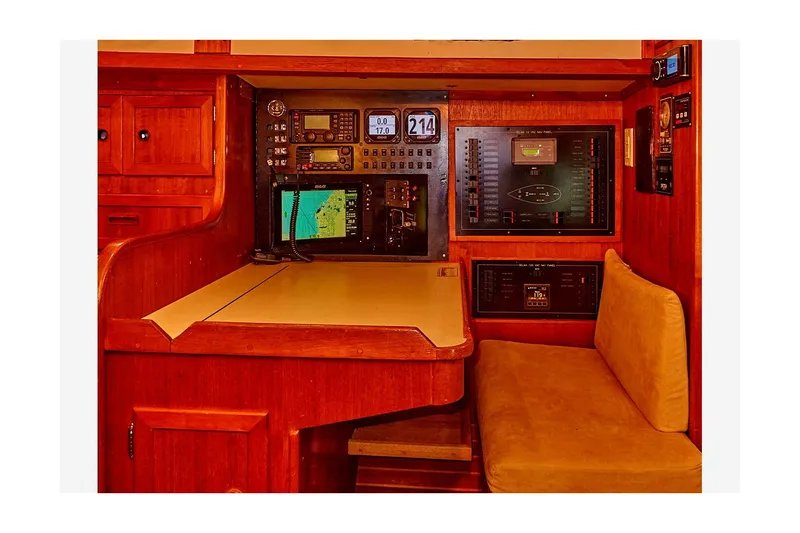 Slide: The Image of Navigation station of 1983 Valiant 40 Selah yacht with electronic equipment and seating. - 50