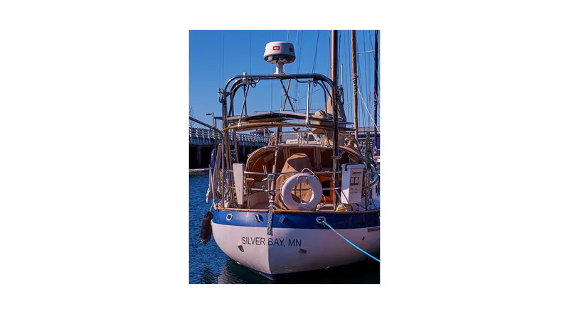 Slide: The Image of 1983 Valiant 40 Selah sailboat docked, rear view, with lifebuoy and radar equipment. - 6