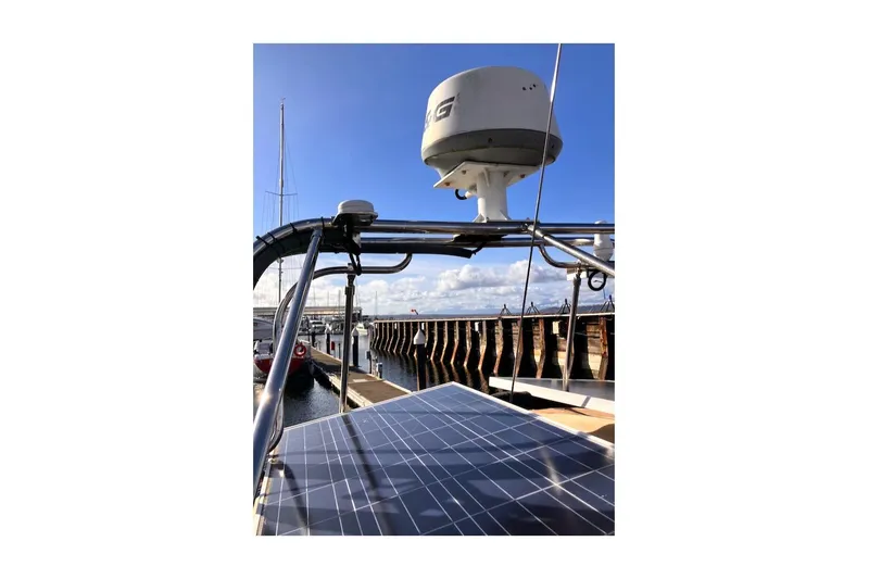 Slide: The Image of 1983 Valiant 40 Selah sailboat with solar panel and radar at marina. - 7