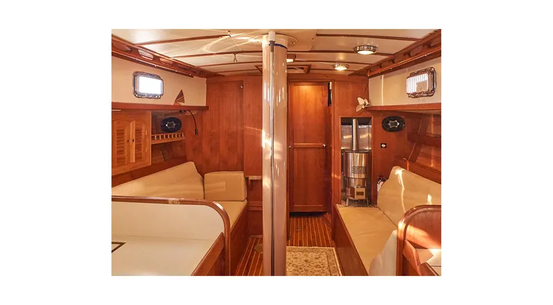 Slide: The Image of 1983 Valiant 40 Selah yacht interior with wooden finish and cozy seating area. - 8
