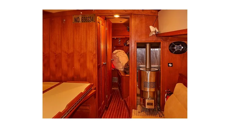 Slide: The Image of Interior of 1983 Valiant 40 Selah yacht with wooden paneling and cozy cabin space. - 9