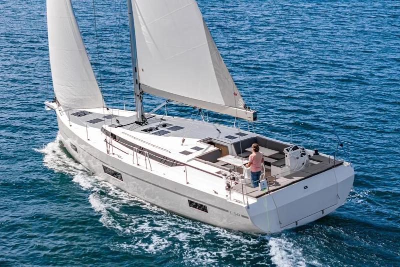 The Image of 2024 Bavaria C50 yacht sailing on open sea with white sails. - 0