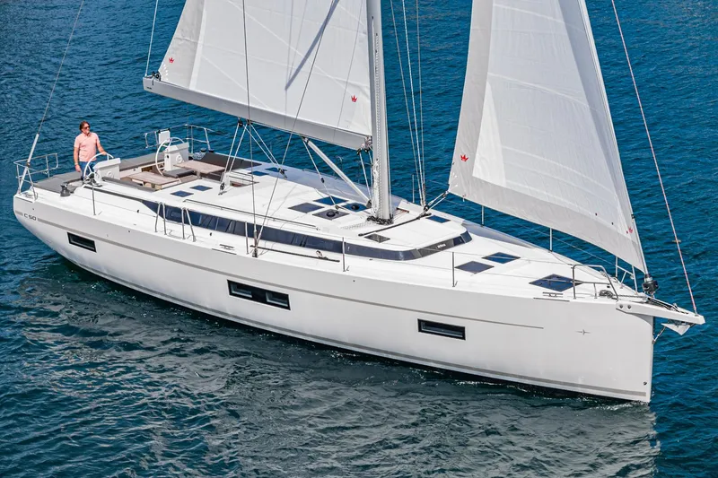 Slide: The Image of 2024 Bavaria C50 sailboat cruising on open water, featuring sleek design and spacious deck. - 2