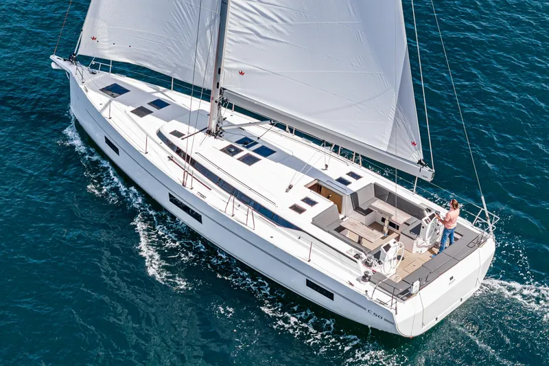 Slide: The Image of 2024 Bavaria C50 yacht sailing on open water, showcasing sleek design and spacious deck. - 21