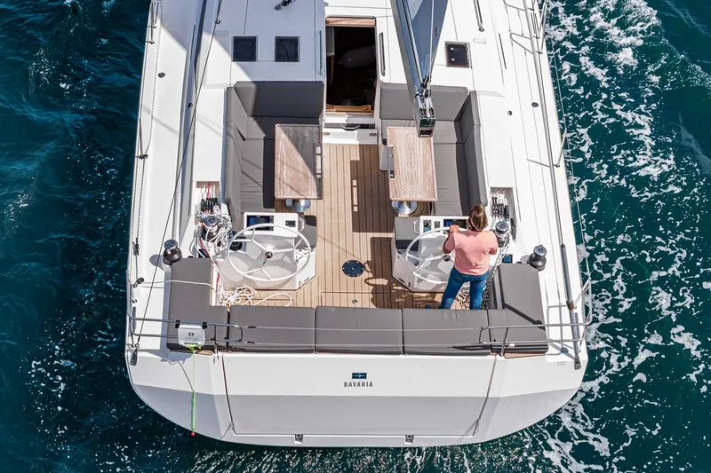 Slide: The Image of 2024 Bavaria C50 yacht sailing on open water, viewed from above. - 26