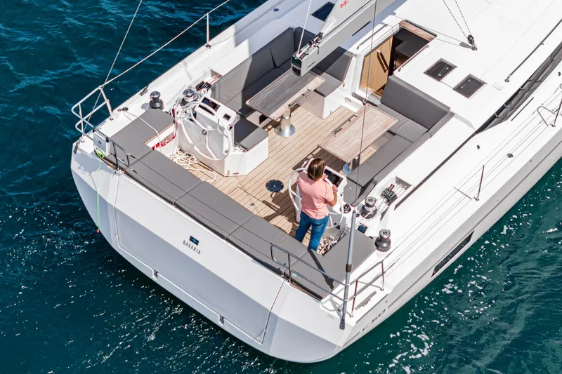 Slide: The Image of 2024 Bavaria C50 yacht on blue water, featuring spacious deck and modern design. - 27
