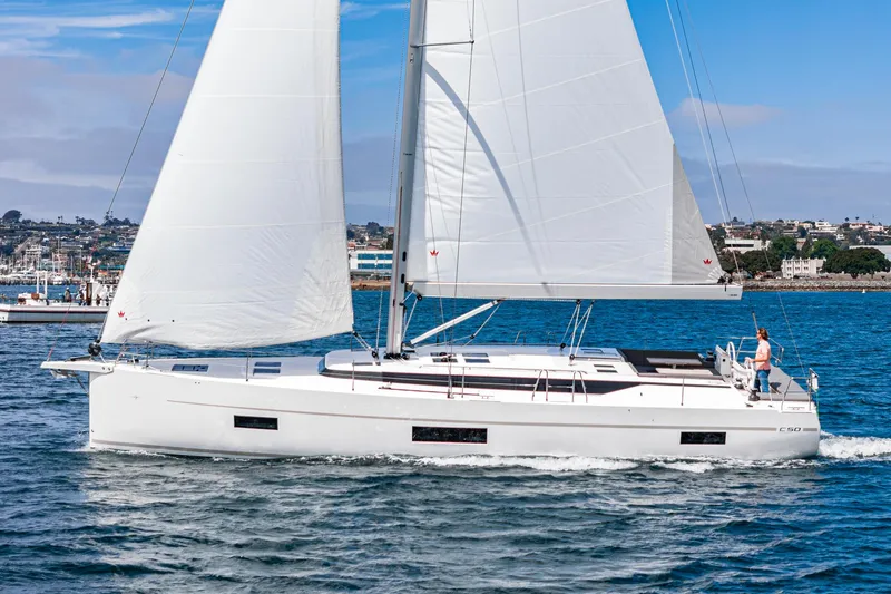 Slide: The Image of 2024 Bavaria C50 sailboat cruising on a sunny day in open waters. - 7